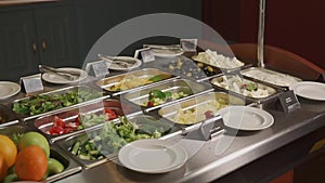 Large plates with salads and appetizers on a buffet