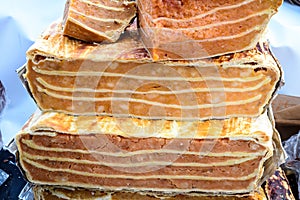 Large portions of freshly home cooked pumpkin pie in display on a table at a street food market, side view photograph of healthy v