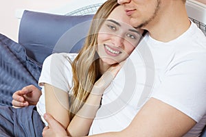 Large portrait : Young lovely couple on bed, morning bedroom. Happy loving couple in the bedroom in morning Copy space . Family