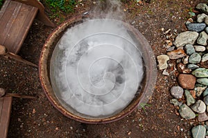 A large pot or pan over a fire while preparing a potion or meal, evaporating a large amount of steam while boiling water. Mystical