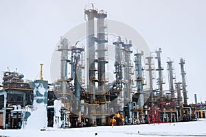 A large powerful industrial installation at an oil refining petrochemical chemical plant with pipe equipment, metal columns,