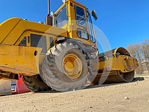 Large powerful modern yellow roller for asphalt paving, repair and road construction. New construction machinery and equipment at