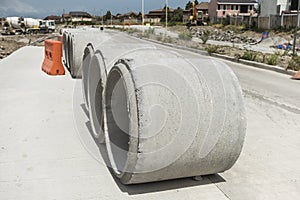Large Precast concrete pipe segments prepared on a road for sewage, storm drain or water supply project