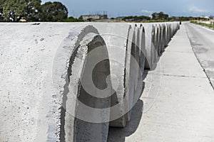 Large Precast concrete pipe segments prepared on a road for sewage, storm drain or water supply project