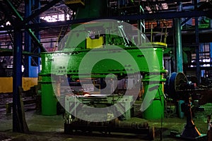 Large pressing machine in the industrial shop forging plant. Production machines, equipment and heavy iron stamping in the industr