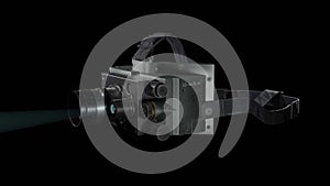 Large professional video camera with a bright light glinting off its lens on a black background