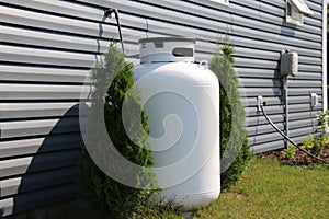 A large propane tank on the side of a house