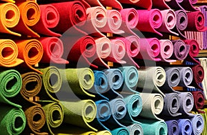 Large quantities of felt fabric rolls stored on shelves in a wholesale craft warehouse