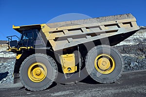 Large quarry dump truck. Loading the rock in the dumper. Loading