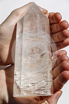 Large quartz crystal in hands