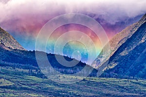 Large rainbow wall across the west Maui mountains.