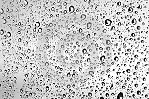 Large raindrops on a window glass in rainy cloudy day against a gray sky. Autumn, depressive, rainy weather. Selective focus