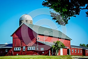 Large Red Barn With White Windows and Silo