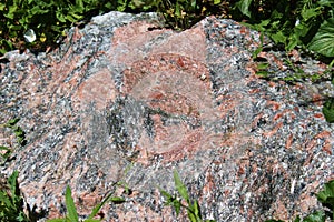 A large red and black Feldspar, Quartz and Granite mixed rock