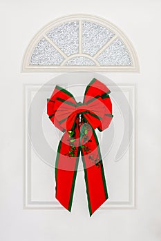 Large Red Bow Hanging on White Door