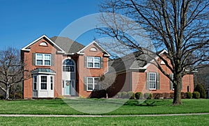 Large Red Brick Home with Bay Window & Arched Entry