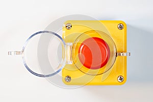 Large red emergency stop button see from above, top view, with open cover, industrial workplace safety, heavy-duty machine stop