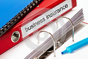 Large red folder for business insurance documents including blue ring binder and blue maker