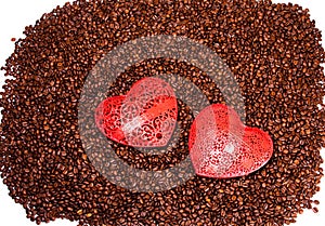 Large red heart sitting on top of scatterred coffee beans