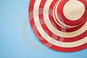 Large red lady hat on blue wooden background with copy space, tr