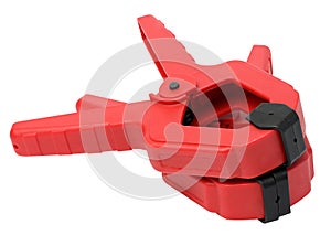 Large red plastic clamp on a white isolated background
