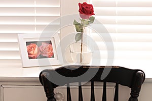 Large red rose on a shabby chic desktop
