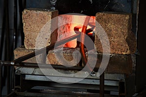 Blacksmith oven fire in workshop for metal heeting