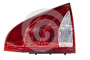 A large red and white taillight of a Truck on metal. Car interior left rear tail light brake stop light taillights fog lamps for