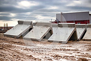 Large reinforced concrete structures at the construction site. Preparation for the installation of reinforced concrete products.