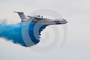 A large rescue plane dumps water to extinguish a fire photo