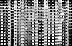 Large residential building with many windows in black and white
