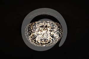 Large retro glass chandelier on ceiling in dark