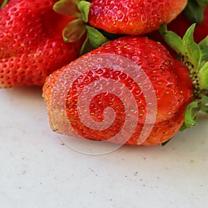 Large ripe red juicy strawberries on a white background