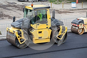 Large road-roller paving a road.