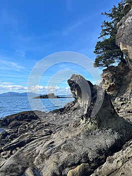 Large rock formation is situated picturesquely on the edge of a tranquil bay photo
