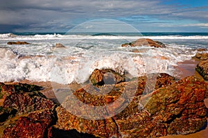 Large rock formations on sandy beach at Port Macquarie Australia