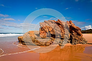 Large rock formations on sandy beach at Port Macquarie Australia