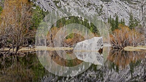 a large rock in mirror lake on a sunny winter at yosemite