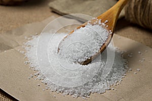 Large rock sea salt on a brown background.