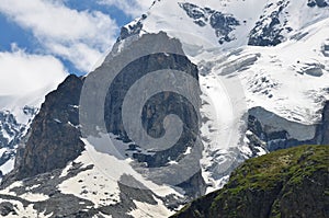 A large rock on a snow-covered mountain