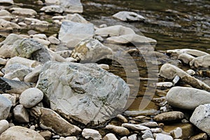 Large rocks in river water.