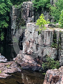 Large rocks by water at Dells of Eau Claire County Park in Wisconsin