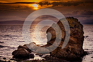 Large rocky coastline at Dunoon on late summer night. photo