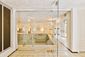 a large room with a pool and a glass door