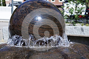 Large rotating marble stone in water fountain