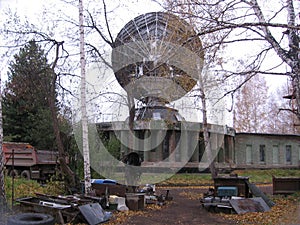 Large round antenna for receiving signals military communications tower secret satellite transmitter orbital station in the forest