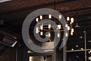 A large round chandelier in a cafe. It was taken indoors.