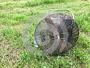 Large round powerful industrial professional metal iron fan with louvres for injecting air into the balloon against the background