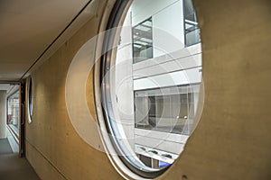 Large round windows on a grey concrete wall in a straight row