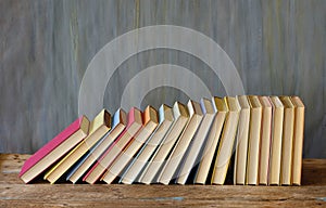 Large row of books on dark background. Reading,literature,education,library,home office, back to school concept,copy space